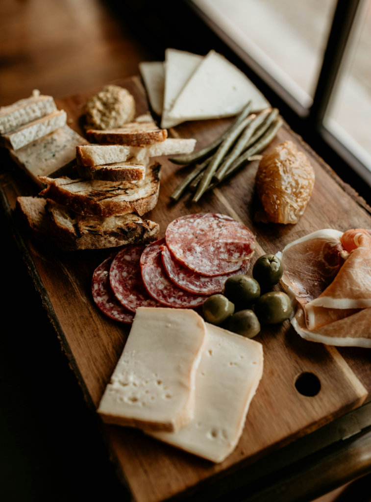 Charcuterie board with bread and olives