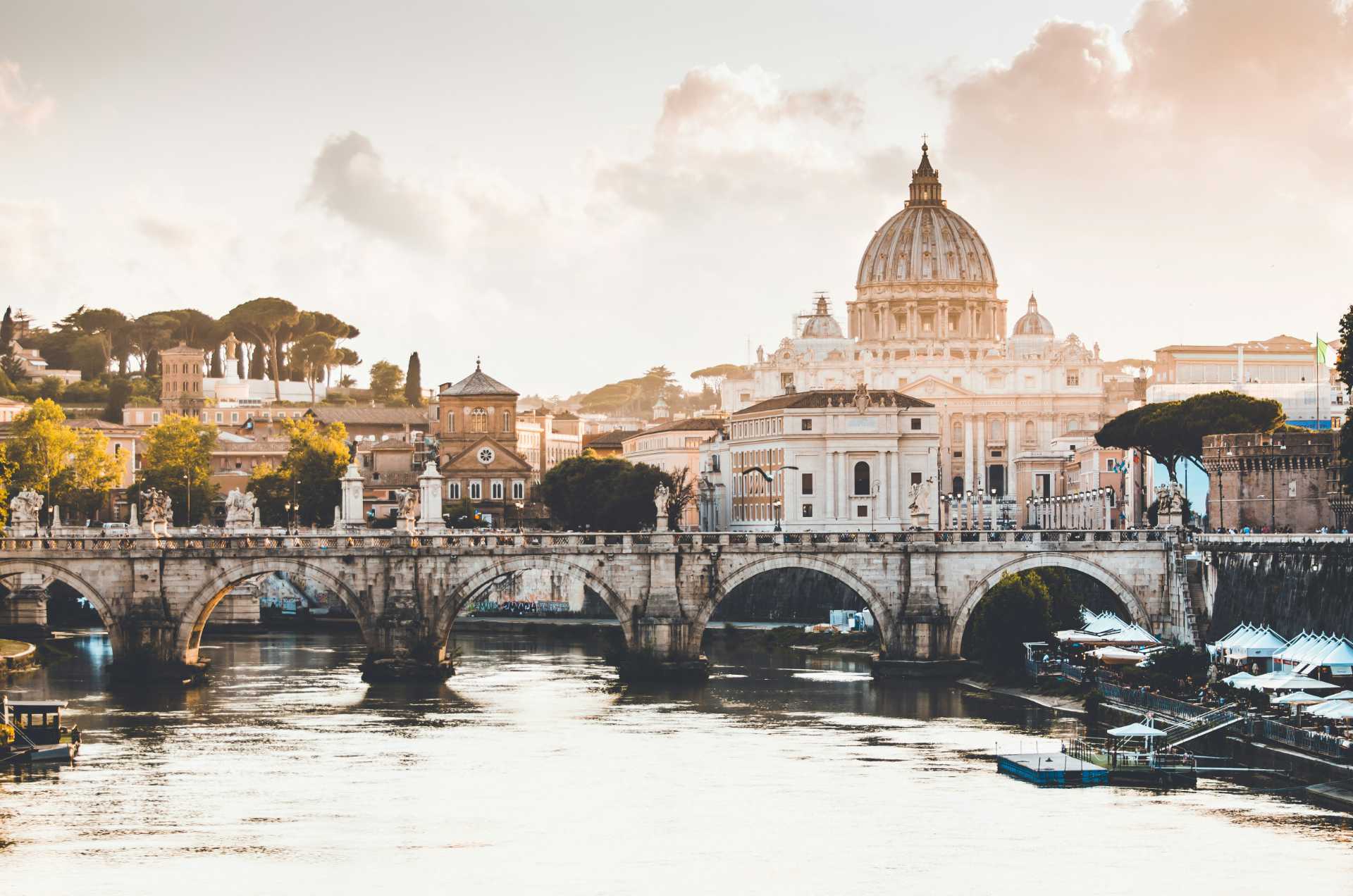 A river and bridge in Rome during the golden hour.