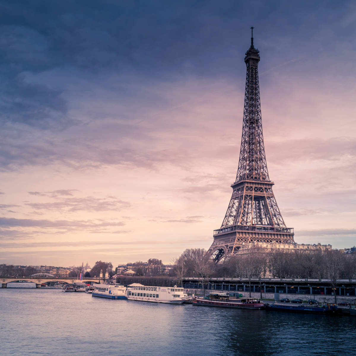 Eiffel tower at dusk from the Seine river.
